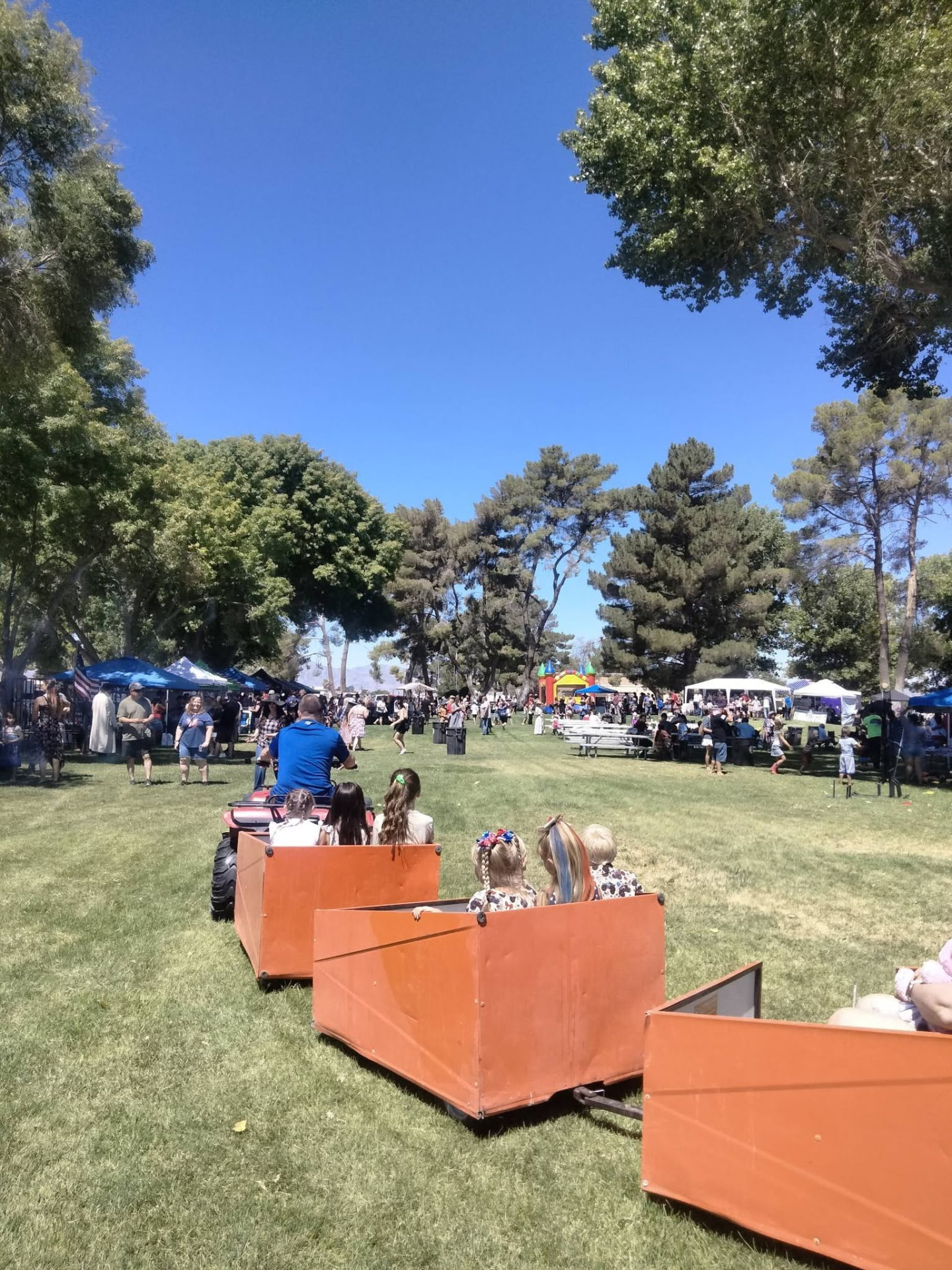 Volunteers cooking burgers on the grill at a community celebration